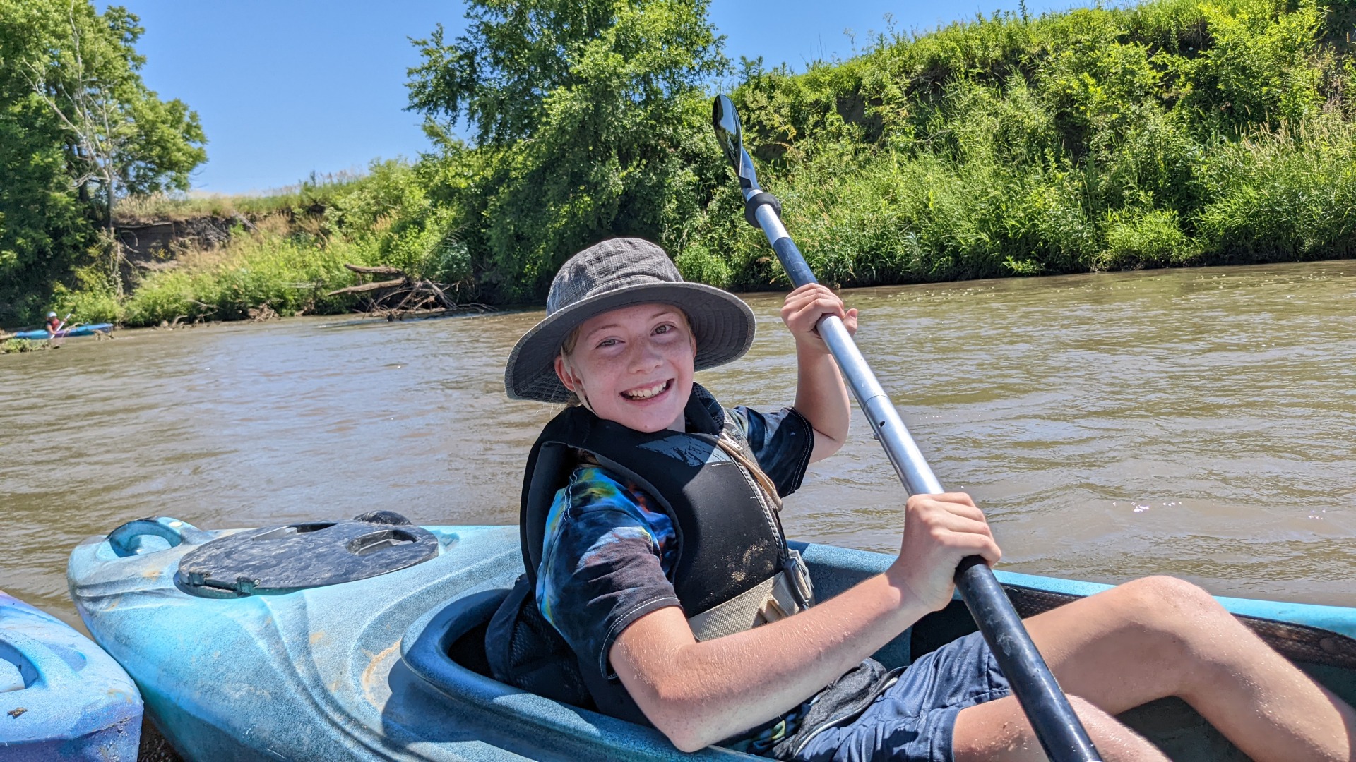 A young learner adventures down the West Nishnabotna River Water Trail on a kayak during an overnight camping camping.