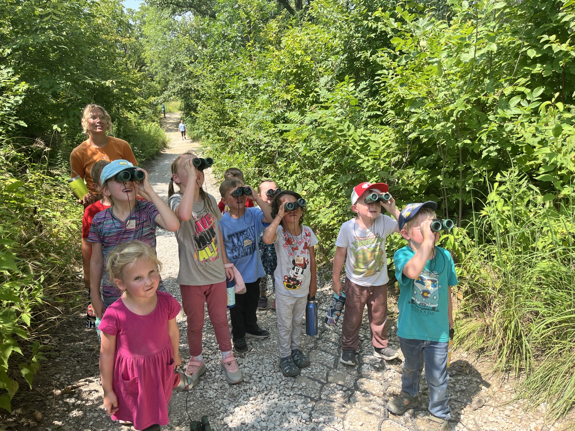 Young learners learn how to use binoculars and tap into their senses to discover wildlife in the woods.woods